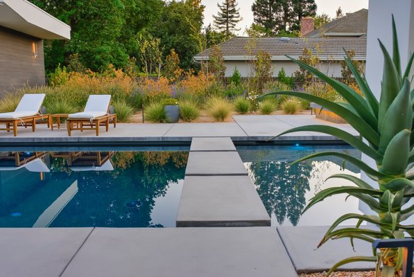 Sierra Oaks Modern Living - This stunning pool construction was a collaborative effort between our team, the architect, and the home builder, resulting in a truly unique outdoor oasis. The design features custom fountains adorned with original sculptures, adding a touch of artistry and elegance to the space. Floating steps create a seamless transition from the pool to the surrounding area, enhancing the overall aesthetic. Additionally, the elegant lighting throughout the pool area not only illuminates the space beautifully at night but also highlights the intricate details of the design, creating a serene and inviting atmosphere for relaxation and entertainment. This project exemplifies the perfect blend of functionality and artistry, making it a standout feature of the home. Sierra Oaks Modern Living - This stunning pool construction was a collaborative effort between our team, the architect, and the home builder, resulting in a truly unique outdoor oasis. The design features custom fountains adorned with original sculptures, adding a touch of artistry and elegance to the space. Floating steps create a seamless transition from the pool to the surrounding area, enhancing the overall aesthetic. Additionally, the elegant lighting throughout the pool area not only illuminates the space beautifully at night but also highlights the intricate details of the design, creating a serene and inviting atmosphere for relaxation and entertainment. This project exemplifies the perfect blend of functionality and artistry, making it a standout feature of the home.