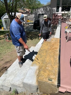 Barrett retaining walls, patio and handrails - Custom hand carved concrete retained wall with splatter texture patio coating as well as wrought iron security railing Barrett retaining walls, patio and handrails - Custom hand carved concrete retained wall with splatter texture patio coating as well as wrought iron security railing
