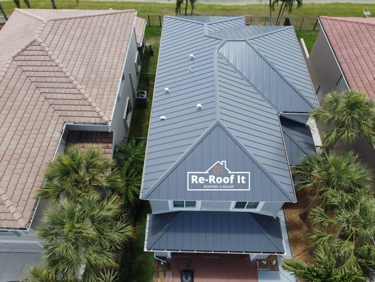 Metal Roof Replacement - Palm Beach County - New Metal roof replacement in Palm Beach County. We added a new SolaTube skylight to enhance the clients kitchen lighting.  Customer was so happy with the job that she left a testimonial. Check out our website to see the full video!