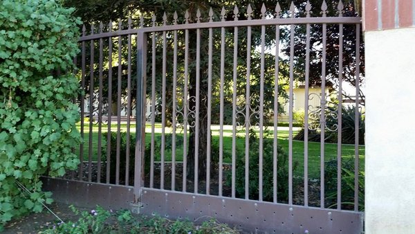 Before and After - Wrought Iron fence before sanding and painting