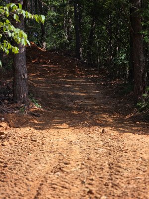 Driveway grading - This customer purchased 5 acres also heavily wooded. This is the driveway that was very narrow and steep. working on widening it and making the incline not as steep. Driveway grading - This customer purchased 5 acres also heavily wooded. This is the driveway that was very narrow and steep. working on widening it and making the incline not as steep.