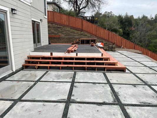 Deck construction - This wooden deck construction was added to an Oakland hills home. The customer wanted to upgrade their outdoor space to make it more user friendly and easier to entertain. We were hired to construct the new deck, stairs and install a matching railing. The deck wraps all the way around the side of the house and includes stairs down from the back door and up to the next level. Here you can see the many stages of the project from start to finish. Deck construction - This wooden deck construction was added to an Oakland hills home. The customer wanted to upgrade their outdoor space to make it more user friendly and easier to entertain. We were hired to construct the new deck, stairs and install a matching railing. The deck wraps all the way around the side of the house and includes stairs down from the back door and up to the next level. Here you can see the many stages of the project from start to finish.