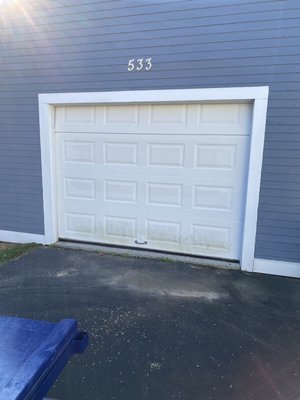 Rollinsford, NH - Removed old door and chiseled out the cement lip preventing the door to sit flush with the garage floor. Install new garage door with short raised panel sections with a long panel glass top. Install a side mount Opener. Rollinsford, NH - Removed old door and chiseled out the cement lip preventing the door to sit flush with the garage floor. Install new garage door with short raised panel sections with a long panel glass top. Install a side mount Opener.