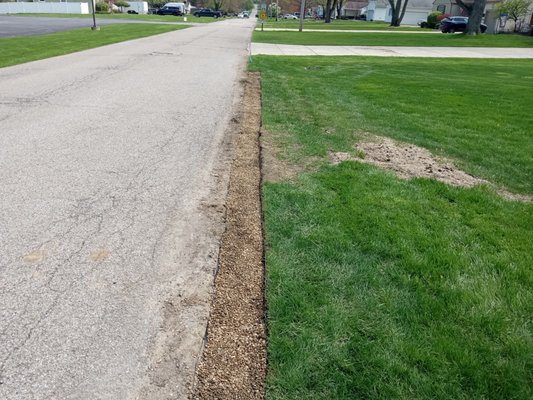 Curbside pea stone barrier - This landscaping job was done to protect the lawn on a property without a curb. Curbside pea stone barrier - This landscaping job was done to protect the lawn on a property without a curb.
