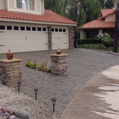 DRIVEWAYS - Whether of stone, concrete or pavers, we can create your custom driveway with a matching integrated entry walkway and front yard landscaping.