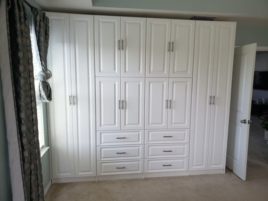 Wardrobe Walls - Short on space in the master closet? We can take a spare wall and extend your closet with a custom-designed WARDROBE WALL.

A wardrobe wall contains everything that you will include in a Closet, except we place doors and drawer fronts that make the installation a unique and comfortable way to extend your personal storage space.