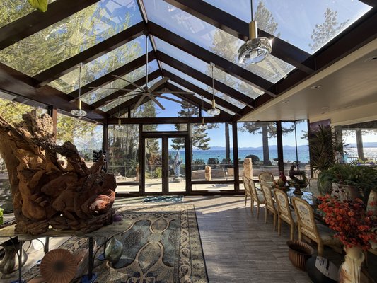 Luxury Lakefront Sunroom Cooling Solution - This stunning lakefront sunroom had one major problem, despite running the air conditioning at full blast, the room would still reach 86°F on sunny days due to the massive amount of solar heat coming through the glass walls and ceiling.
The homeowners loved the natural light and incredible views but needed a solution that would make the space comfortable year round. We installed a high performance solar control window film designed to reject a significant amount of solar heat while maintaining the room's open, bright appearance.
The results were dramatic. After installation, the room stabilized at approximately 68°F without the air conditioning running, transforming it from one of the hottest rooms in the home into one of the most comfortable. In addition to the temperature improvement, the film reduced glare, blocked 99% of harmful UV rays, and helped protect furniture, flooring, and decor from sun damage. Luxury Lakefront Sunroom Cooling Solution - This stunning lakefront sunroom had one major problem, despite running the air conditioning at full blast, the room would still reach 86°F on sunny days due to the massive amount of solar heat coming through the glass walls and ceiling.
The homeowners loved the natural light and incredible views but needed a solution that would make the space comfortable year round. We installed a high performance solar control window film designed to reject a significant amount of solar heat while maintaining the room's open, bright appearance.
The results were dramatic. After installation, the room stabilized at approximately 68°F without the air conditioning running, transforming it from one of the hottest rooms in the home into one of the most comfortable. In addition to the temperature improvement, the film reduced glare, blocked 99% of harmful UV rays, and helped protect furniture, flooring, and decor from sun damage.