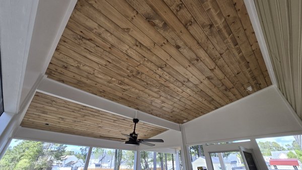 Exterior Shiplap Ceiling - The existing vinyl ceiling panels over this covered deck area had begun warping and failing from prolonged heat exposure. Strictly Renovations removed the damaged material and upgraded the space with a new wood plank ceiling installation for improved durability and appearance. The new ceiling was custom stained to the homeowner’s preferred finish, creating a warmer and more natural look that transformed the entire outdoor living area. Exterior Shiplap Ceiling - The existing vinyl ceiling panels over this covered deck area had begun warping and failing from prolonged heat exposure. Strictly Renovations removed the damaged material and upgraded the space with a new wood plank ceiling installation for improved durability and appearance. The new ceiling was custom stained to the homeowner’s preferred finish, creating a warmer and more natural look that transformed the entire outdoor living area.