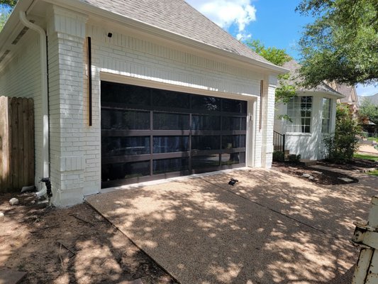 Black Full-View Garage Door - This was a garage door replacement that was custom built with glass panels. Black Full-View Garage Door - This was a garage door replacement that was custom built with glass panels.