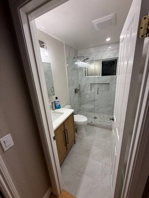 Bathroom renovation - This bathroom renovation included full wall preparation and painting, flooring work, electrical updates including outlets, plumbing adjustments, and installation of a new toilet and vanity. We also installed a glass shower door, new lighting fixtures, an exhaust fan, mirrors, and an audio system with reconnection.

All materials and finishes were selected in collaboration with the homeowner to match their preferences and style. Throughout the project, we coordinated each step to ensure the final result met the desired design and functionality.