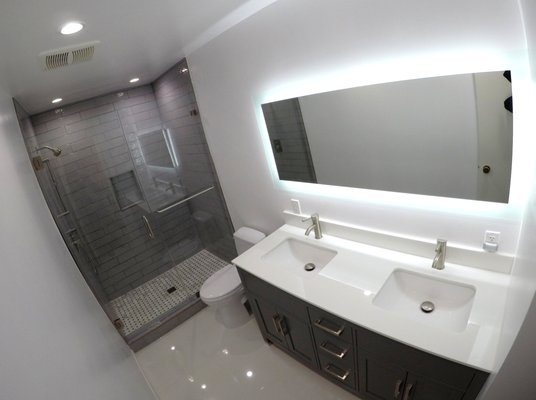 Bathroom Remodel - Model C - This is a complete bathroom remodel with new shower pan, a custom frame-less glass shower door, custom sink vanity, new flooring and tiles. Bathroom Remodel - Model C - This is a complete bathroom remodel with new shower pan, a custom frame-less glass shower door, custom sink vanity, new flooring and tiles.