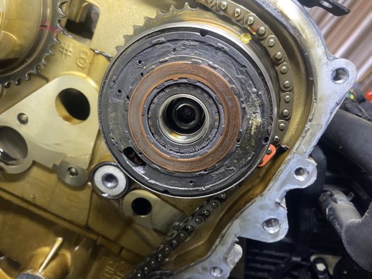 2015 Hyundai Sonata E-CVVT Gear - On almost every example of variable valve timing(VVT) ever utilized, it is controlled by oil pressure, a solenoid that directs oil to the cam gear to advance or retard cam timing. For many Hyundai and Kia models made in the mid 2010s, they used an electric motor to control the cam timing on the intake side. This electric motor is actuated via graphite tabs that contact copper rings on the surface of the cam gear. In theory, the graphite tabs should wear out long before the surface of the cam gear, throwing a P0010 code for the E-CVVT circuit. All that would need to be replaced in that case is a $40-50 part with new tabs. In reality, the early examples of this technology used a graphite composite that was too hard, and the copper ring on the cam gear wore down before the graphite contacts. Eventually they would wear through entirely and damage the cam gear itself, turning into quite a costly and labor intensive repair! Correct fix in this case is to replace cam gear, all timing chain components, as well as the updated actuator with contacts. 2015 Hyundai Sonata E-CVVT Gear - On almost every example of variable valve timing(VVT) ever utilized, it is controlled by oil pressure, a solenoid that directs oil to the cam gear to advance or retard cam timing. For many Hyundai and Kia models made in the mid 2010s, they used an electric motor to control the cam timing on the intake side. This electric motor is actuated via graphite tabs that contact copper rings on the surface of the cam gear. In theory, the graphite tabs should wear out long before the surface of the cam gear, throwing a P0010 code for the E-CVVT circuit. All that would need to be replaced in that case is a $40-50 part with new tabs. In reality, the early examples of this technology used a graphite composite that was too hard, and the copper ring on the cam gear wore down before the graphite contacts. Eventually they would wear through entirely and damage the cam gear itself, turning into quite a costly and labor intensive repair! Correct fix in this case is to replace cam gear, all timing chain components, as well as the updated actuator with contacts.