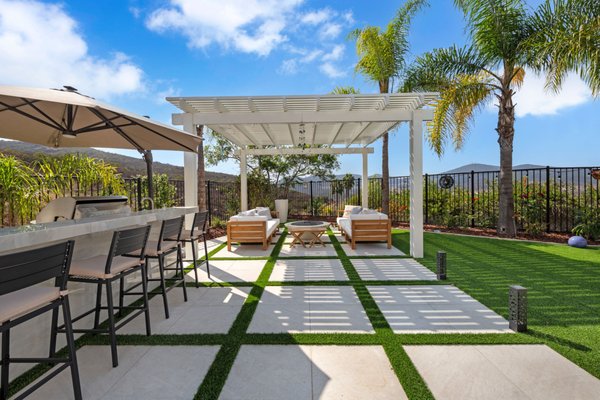San Diego - Backyard Remodel - We transformed the backyard into a modern oasis, featuring lush artificial grass that offers a vibrant, low-maintenance landscape. Elegant porcelain pavers create a stylish pathway, while a fully equipped outdoor kitchen invites culinary adventures. The addition of sleek patio covers provides shade and comfort, making the space perfect for entertaining. This remodel has revitalized the home, giving it a fresh, contemporary appeal!