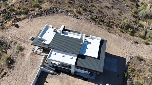 Custom Home in Phoenix, Arizona - This Beautiful Custom home showcases the Beauty of Standing Seam metal while capturing the Energy Efficiency of Polyurethane Foam and Elastomeric Coating. The large Balcony Deck was completed using Westcoats durable ALX system.