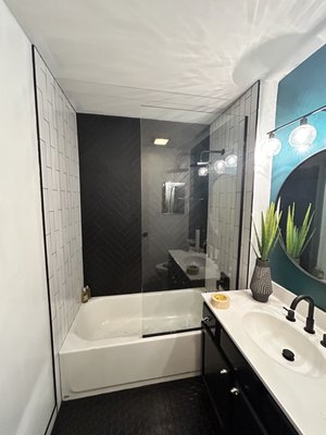 Shower and floor remodel - Shower and floor tile remodel to an outdated bathroom. Bringing to life this new, modern black and white tile combo. Shower and floor remodel - Shower and floor tile remodel to an outdated bathroom. Bringing to life this new, modern black and white tile combo.