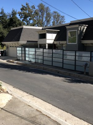 Modern Frosted Glass Privacy Gate – Encino - We designed and installed this sleek privacy fence and pedestrian gate featuring a powder-coated steel frame with frosted glass panels. The system provides both security and style, giving the home a modern curb appeal while maintaining privacy.