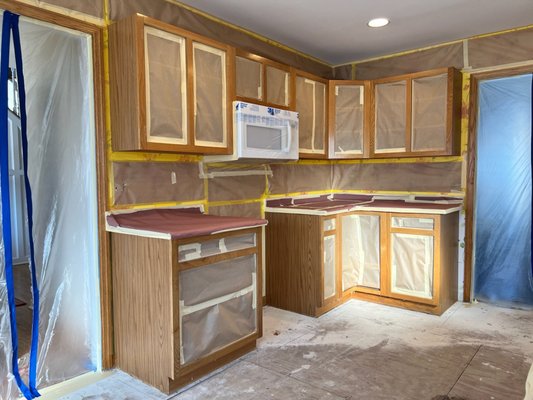 Kitchen Transformation - Careful masking and excellent workmanship transformed these outdated cabinets while leaving the adjacent wallpaper untouched! Kitchen Transformation - Careful masking and excellent workmanship transformed these outdated cabinets while leaving the adjacent wallpaper untouched!