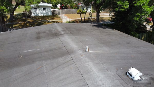 Flat Roof Elastomeric Coating - This was a flat roof that the customer wanted sealed and coated before we applied the coating we checked all the seams to identify any openings, after we sealed all the opened seams we applied sealant to all the penetrations then followed up with to coats of elastomeric roof coating
