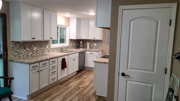 kitchens Remodels - Complete kitchen renovation with white shaker cabinets, granite countertops, mosaic tile backsplash, and waterproof vinyl plank flooring. kitchens Remodels - Complete kitchen renovation with white shaker cabinets, granite countertops, mosaic tile backsplash, and waterproof vinyl plank flooring.