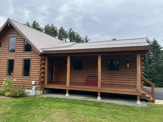 Remove Metal Roof, and Replace with Asphalt - Who said a Roof isn’t beautiful?  This transition to a charcoal roof with black drip metal, and black sidewall flashing allows the logs from the cabin to truly stand out.

This Complex transition was originally in Standing Seam Metal Roofing and was installed incorrectly leaving continuous leaks. We offered to try to repair it, but with metal, there is no guarantee when it comes to another company's installation. We helped the homeowner choose to remove metal and transition to asphalt as it was the safest to guarantee no leaks, and still be affordable.