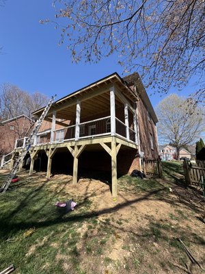 Deck and Roof - Would you like to sit outside under the shade overlooking your backyard? Call us! Our customer requested a porch with a roof covering half and stairs leading down to their yard. Deck and Roof - Would you like to sit outside under the shade overlooking your backyard? Call us! Our customer requested a porch with a roof covering half and stairs leading down to their yard.