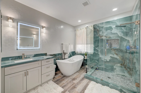 Bright Bathroom Remodel - A sleek, modern bathroom transformation! We reimagined this space with a luxurious freestanding tub in place of the old bulky square tub, paired with a spacious standing shower and stylish lit mirrors for a touch of elegance. The new tile walls and flooring add durability and visual appeal, while custom cabinetry, updated hardware, and quartz countertops bring functionality and sophistication. Every detail, from the contemporary light fixtures to the polished finishes, was thoughtfully curated to create a serene and inviting retreat. Ready to turn your bathroom into a spa-like oasis? Let’s make it happen! Bright Bathroom Remodel - A sleek, modern bathroom transformation! We reimagined this space with a luxurious freestanding tub in place of the old bulky square tub, paired with a spacious standing shower and stylish lit mirrors for a touch of elegance. The new tile walls and flooring add durability and visual appeal, while custom cabinetry, updated hardware, and quartz countertops bring functionality and sophistication. Every detail, from the contemporary light fixtures to the polished finishes, was thoughtfully curated to create a serene and inviting retreat. Ready to turn your bathroom into a spa-like oasis? Let’s make it happen!