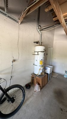 Tankless retro-fit from 40 gallon tank in garage. - This is a replacement of an older 40 gallon natural gas, atmospheric vent tank, water heater, upgraded to a Navien 240 tankless water heater. We retrofitted the venting, waters, gas and added a condensate drain pipe. Customer now has a 96% efficient tankless water heater with endless hot water instead of a 62% efficient limited storage tank water heater. Tankless retro-fit from 40 gallon tank in garage. - This is a replacement of an older 40 gallon natural gas, atmospheric vent tank, water heater, upgraded to a Navien 240 tankless water heater. We retrofitted the venting, waters, gas and added a condensate drain pipe. Customer now has a 96% efficient tankless water heater with endless hot water instead of a 62% efficient limited storage tank water heater.