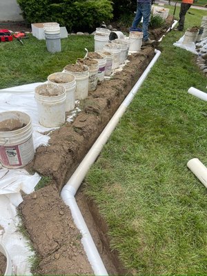 Stormwater container and yard drainage - This project was completed to get rid of pooling areas of water and give our client a more usable yard space.
