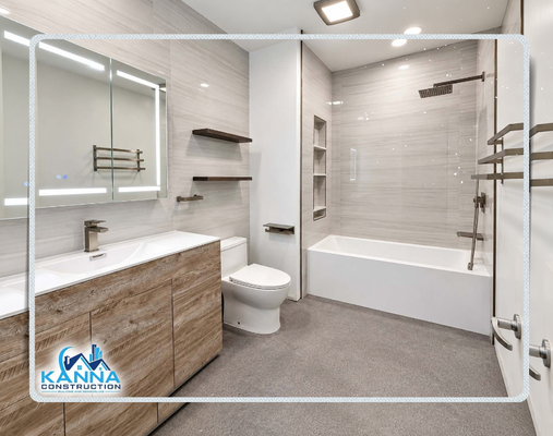 Downtown San Diego | Custom Spa Bathroom - Transformed an existing space into a serene, contemporary oasis highlighting clean architectural lines, premium natural textures, and smart bath features. Completed by Kanna Construction, this remodel blends high-end functionality with minimalist design.
Floating Natural-Wood Vanity: Features a double floating vanity with warm, raw-wood grain cabinetry, sleek handleless fronts, and integrated white porcelain basins with modern dark nickel hardware.
Smart LED Mirror & Storage: Frameless medicine cabinet paired with integrated perimeter LED task lighting, touch-screen controls, and floating dark wood accent shelves.
Deep Soaking Tub & Shower Tower: Clean-lined rectangular soaking tub paired with large-format stone-look wall panels, an integrated multi-tier recessed shelf niche, and an overhead rain shower system with hand sprayer.
Seamless Stone Surrounds: Subtle linear-veined wall tiles spanning floor-to-ceiling alongside modern dark grey terrazzo-style floor tile for balanced texture.
Modern Comfort Fixtures: Outfitted with a wall-mounted heated towel warmer and an elongated modern toilet. Downtown San Diego | Custom Spa Bathroom - Transformed an existing space into a serene, contemporary oasis highlighting clean architectural lines, premium natural textures, and smart bath features. Completed by Kanna Construction, this remodel blends high-end functionality with minimalist design.
Floating Natural-Wood Vanity: Features a double floating vanity with warm, raw-wood grain cabinetry, sleek handleless fronts, and integrated white porcelain basins with modern dark nickel hardware.
Smart LED Mirror & Storage: Frameless medicine cabinet paired with integrated perimeter LED task lighting, touch-screen controls, and floating dark wood accent shelves.
Deep Soaking Tub & Shower Tower: Clean-lined rectangular soaking tub paired with large-format stone-look wall panels, an integrated multi-tier recessed shelf niche, and an overhead rain shower system with hand sprayer.
Seamless Stone Surrounds: Subtle linear-veined wall tiles spanning floor-to-ceiling alongside modern dark grey terrazzo-style floor tile for balanced texture.
Modern Comfort Fixtures: Outfitted with a wall-mounted heated towel warmer and an elongated modern toilet.