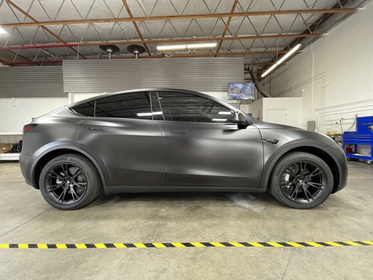 Telsa Model Y wrapped in XPEL Stealth Paint Protection Film - We recently had the privilege of assisting a great customer with the transformation of his Tesla Model Y. As you can see, this vehicle underwent a complete transformation. Firstly, you'll notice that we wrapped the entire vehicle in XPEL Stealth Paint Protection Film. Not only does this film transform the look of the car, but also adds a self-healing layer of protection from road debris and grime. We also installed XPEL's Prime XR Plus ceramic window film that offers up to 98% IR rejection. In addition to the products we installed, the customer chose to have the wheels powder coated in matte black by Powder Craft in Rocklin. Let us know what you think of this project. Telsa Model Y wrapped in XPEL Stealth Paint Protection Film - We recently had the privilege of assisting a great customer with the transformation of his Tesla Model Y. As you can see, this vehicle underwent a complete transformation. Firstly, you'll notice that we wrapped the entire vehicle in XPEL Stealth Paint Protection Film. Not only does this film transform the look of the car, but also adds a self-healing layer of protection from road debris and grime. We also installed XPEL's Prime XR Plus ceramic window film that offers up to 98% IR rejection. In addition to the products we installed, the customer chose to have the wheels powder coated in matte black by Powder Craft in Rocklin. Let us know what you think of this project.