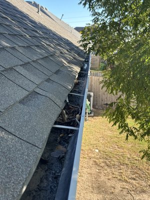 Gutter Cleaning - A clogged gutter packed with leaves and debris transformed into a clean, free-flowing system. Clearing the buildup restores proper drainage, prevents water damage, and keeps the roofline protected. Gutter Cleaning - A clogged gutter packed with leaves and debris transformed into a clean, free-flowing system. Clearing the buildup restores proper drainage, prevents water damage, and keeps the roofline protected.