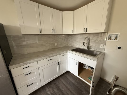 Apartment remodel. - This remodel was done to fix issues the previous contractor had made. Customer wanted more cabinets, butcher block countertops, space for a dishwasher & microwave, subway tile backsplash and shower and cop esthetic finishes