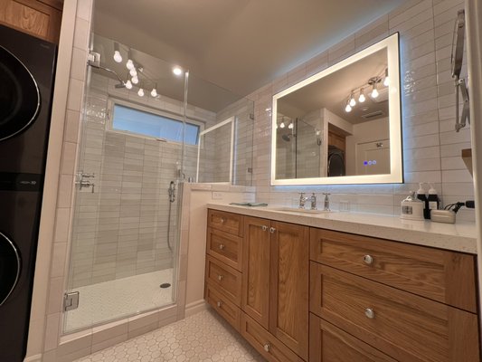 Bathroom remodel -napels island in long beach - Full bathroom remodel in Naples Island, Long Beach. Scope included relocating window above shower, full plumbing and electrical upgrades, new subfloor, and tile flooring leveled flush with existing wood. Custom white oak cabinetry built to house washer/dryer with recessed drain system. Finishes include custom tile work, quartz countertop, LED mirror, old world texture, full interior paint, and exterior stucco patching for a seamless result. Bathroom remodel -napels island in long beach - Full bathroom remodel in Naples Island, Long Beach. Scope included relocating window above shower, full plumbing and electrical upgrades, new subfloor, and tile flooring leveled flush with existing wood. Custom white oak cabinetry built to house washer/dryer with recessed drain system. Finishes include custom tile work, quartz countertop, LED mirror, old world texture, full interior paint, and exterior stucco patching for a seamless result.