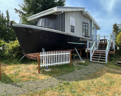Boat Cottage - Where residential design meets authentic nautical feel and character. Our boat cottages are constructed from salvaged wood hulls from Westport's fishing fleet. The Q is a 43' 1970's era former charter boat built from yellow cedar exclusive to the northwest. A spacious feel of the central living and kitchen areas is extended with the height of ceilings and windows that lend to a treehouse kind of connection with canopy of trees that surround. Berthing on The Qualifier divides between a queen size bed room forward, a twin bed loft above it and another twin bed room amidship, accessed by a wrap-around stairway to the kitchen. (Please note that the lofts are not recommended for guests with mobility restrictions or reservations about using narrow stairway or ladder.) A unique weekend get-away to connect with Westport's rich nautical heritage from the serenity of its setting among trees and "boatyard garden" at The Glenacres. Boat Cottage - Where residential design meets authentic nautical feel and character. Our boat cottages are constructed from salvaged wood hulls from Westport's fishing fleet. The Q is a 43' 1970's era former charter boat built from yellow cedar exclusive to the northwest. A spacious feel of the central living and kitchen areas is extended with the height of ceilings and windows that lend to a treehouse kind of connection with canopy of trees that surround. Berthing on The Qualifier divides between a queen size bed room forward, a twin bed loft above it and another twin bed room amidship, accessed by a wrap-around stairway to the kitchen. (Please note that the lofts are not recommended for guests with mobility restrictions or reservations about using narrow stairway or ladder.) A unique weekend get-away to connect with Westport's rich nautical heritage from the serenity of its setting among trees and "boatyard garden" at The Glenacres.