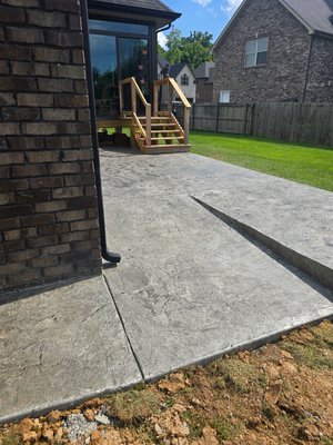 Helping Create Patio Heaven!! - A beautiful stamped with antiquing and sealed amazing new concrete patio with ramp for the lawn mower!!! Thank you SA