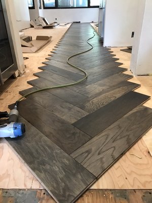Herringbone install - Entire main floor new installation of prefinished herringbone hardwood flooring. Herringbone install - Entire main floor new installation of prefinished herringbone hardwood flooring.