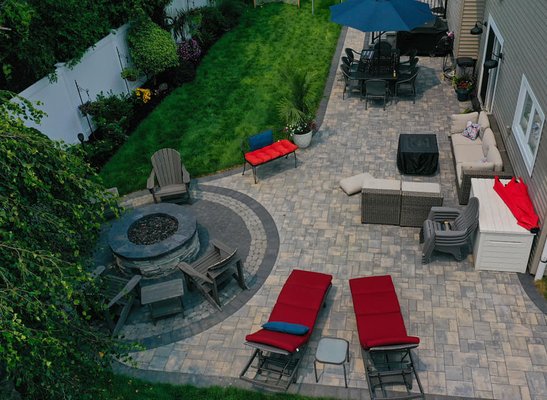 Full Backyard & Driveway Makeover - We gave this Massapequa Park home the full Genstar treatment. On this job we removed the old driveway, apron, and sidewalks. On the driveway and walkway we used Cambridge Montauk Blue 3pc Ledgstone pavers with Coal 6x9 borders and inlays. The sidewalks and apron were constructed from 4000psi cement with wire mesh. We then moved to the backyard which we constructed a new patio, gas fire pit and new steps. The patio was made from Cambridge Montauk Blue 3pc Ledgstone with 6x9 Coal borders, the gas fire pit was constructed from Echoridge cultured stone with Coal capping and a Coal river rock with a Onyx Natural river rock border, the steps were made from Cambridge Onyx Natural Old English block with 12 x 24 Cambridge Onyx Natural Caps. All the joints were then filled in with a slate polymeric sand. Full Backyard & Driveway Makeover - We gave this Massapequa Park home the full Genstar treatment. On this job we removed the old driveway, apron, and sidewalks. On the driveway and walkway we used Cambridge Montauk Blue 3pc Ledgstone pavers with Coal 6x9 borders and inlays. The sidewalks and apron were constructed from 4000psi cement with wire mesh. We then moved to the backyard which we constructed a new patio, gas fire pit and new steps. The patio was made from Cambridge Montauk Blue 3pc Ledgstone with 6x9 Coal borders, the gas fire pit was constructed from Echoridge cultured stone with Coal capping and a Coal river rock with a Onyx Natural river rock border, the steps were made from Cambridge Onyx Natural Old English block with 12 x 24 Cambridge Onyx Natural Caps. All the joints were then filled in with a slate polymeric sand.