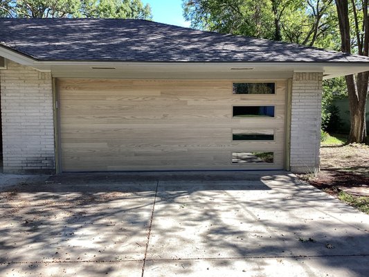 Natural Oak Plank Garage Door - Do you love the Accent Woodtone look, but hope for a lighter color? This Natural Oak Plank style door is a great options, and perfectly accents the light brick of this home! Ready for an upgrade! Call us today for your free on-site estimate! You can reach us at (972)-422-1695 or PlanoOverhead.com/contact-us/ Natural Oak Plank Garage Door - Do you love the Accent Woodtone look, but hope for a lighter color? This Natural Oak Plank style door is a great options, and perfectly accents the light brick of this home! Ready for an upgrade! Call us today for your free on-site estimate! You can reach us at (972)-422-1695 or PlanoOverhead.com/contact-us/