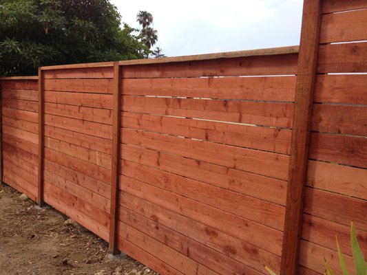 Horizontal Redwood Fence - We gave the traditional, wooden fence a modern touch by installing the wood horizontally instead of vertically.