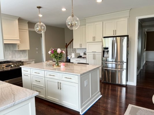 White Lake Kitchen Remodel - This remodel was a Redoor plus. We extended the existing cabinets to the ceiling, modified, the island, built a custom vent hood cover, modified the pantry, and changed the bar area. Everything was painted and new doors were installed.