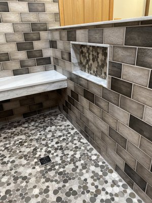 Bathroom shower remodel - Large shower remodel with all new tile work, bench seat, niche, new vanity and mirrors, and new flooring.