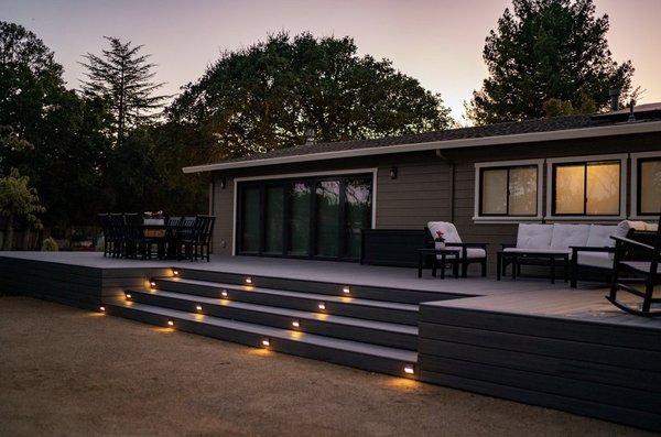 Backyard patio deck - This outdoor oasis is a true gem, offering a perfect blend of natural beauty and modern comfort. With its sleek Trex decking, this patio invites you to soak in the serene atmosphere, surrounded by lush greenery and the soft, warm glow of carefully placed lighting. Whether you're looking for a relaxing spot to enjoy a meal, sip a drink, or unwind with friends and family, this Trex deck patio promises an unforgettable experience. Join me on this virtual journey to explore the aesthetics, ambiance, and all-around excellence of this delightful space! Backyard patio deck - This outdoor oasis is a true gem, offering a perfect blend of natural beauty and modern comfort. With its sleek Trex decking, this patio invites you to soak in the serene atmosphere, surrounded by lush greenery and the soft, warm glow of carefully placed lighting. Whether you're looking for a relaxing spot to enjoy a meal, sip a drink, or unwind with friends and family, this Trex deck patio promises an unforgettable experience. Join me on this virtual journey to explore the aesthetics, ambiance, and all-around excellence of this delightful space!