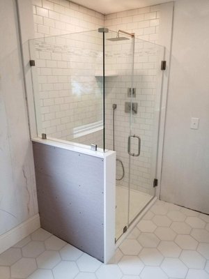 Shower enclosure - Custom shower enclosures. Heavy glass door w/ sidelite and return on buttress is shown Shower enclosure - Custom shower enclosures. Heavy glass door w/ sidelite and return on buttress is shown