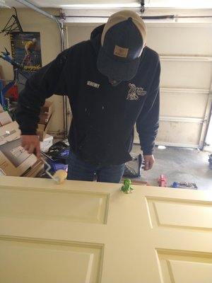Painting door - Removed two doors, painted them white, and reinstalled both doors.