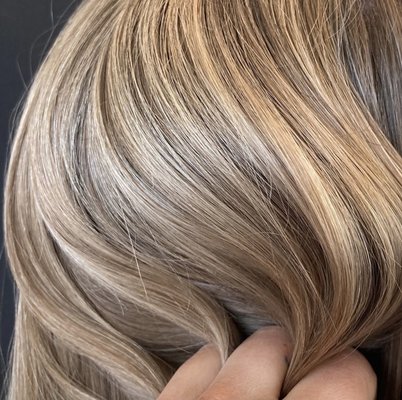 Highlights - A highlighting hair coloring service involves adding lighter shades of color to specific sections of the hair to create contrast and dimension. Highlights can range from subtle, natural-looking streaks to more dramatic, high-contrast pieces. They’re a popular choice for adding depth and dimension to hair, creating a sun-kissed look, or just making your color pop.
