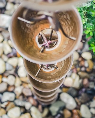 Rain Chains - Rain chains are a beautiful and functional alternative to traditional downspouts, turning a simple part of your gutter system into a feature that enhances your home. Unlike the loud rush of water in enclosed downspouts, rain chains create a softer, soothing sound as water cascades down each link or cup—almost like a miniature waterfall. They add aesthetic appeal too, serving as a decorative element that blends practicality with design, especially when placed near patios, gardens, or entryways. Copper rain chains in particular stand out, because not only do they resist rust and last for decades, but they also develop a natural patina over time, shifting from a shiny new-penny look to a rich green or brown that adds character and charm to your home’s exterior. Rain Chains - Rain chains are a beautiful and functional alternative to traditional downspouts, turning a simple part of your gutter system into a feature that enhances your home. Unlike the loud rush of water in enclosed downspouts, rain chains create a softer, soothing sound as water cascades down each link or cup—almost like a miniature waterfall. They add aesthetic appeal too, serving as a decorative element that blends practicality with design, especially when placed near patios, gardens, or entryways. Copper rain chains in particular stand out, because not only do they resist rust and last for decades, but they also develop a natural patina over time, shifting from a shiny new-penny look to a rich green or brown that adds character and charm to your home’s exterior.