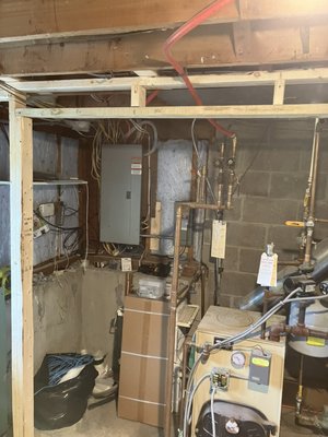 Carver, MA basement bathroom install (In Progress) - These owners wanted to put a second full bathroom down in their basement. The entrance wall of the eventual bathroom had a set of filtration tanks and a pump that needed to be disassembled and relocated before the plumbing could be stubbed out, walls framed and sheet rock put up. Carver, MA basement bathroom install (In Progress) - These owners wanted to put a second full bathroom down in their basement. The entrance wall of the eventual bathroom had a set of filtration tanks and a pump that needed to be disassembled and relocated before the plumbing could be stubbed out, walls framed and sheet rock put up.
