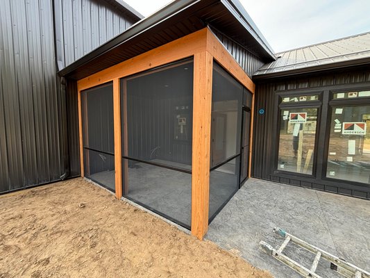 Screen Porch - Allegan - This porch was screened in for a new construction barndominium in Allegan, MI. The black frame matches the dark aluminum screen and contrasts with the wood accents. Screen Porch - Allegan - This porch was screened in for a new construction barndominium in Allegan, MI. The black frame matches the dark aluminum screen and contrasts with the wood accents.