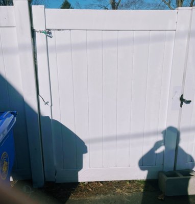 Vinyl Fence gate - This Vinyl white fence was broken by the strong wind . The rest of the fence was already  fixed and we just had to do the gate  which it didn't take so long ,So first we removed the old and broken one  and then we put on the new one .This was the final result