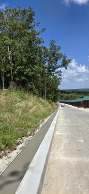 Concrete Curb - Completed this concrete curb in 2025 for road runoff drainage. The curb length was 2,000 ft, and a concrete slope was installed on the back side of the curb to allow water to flow effectively to drain. Concrete Curb - Completed this concrete curb in 2025 for road runoff drainage. The curb length was 2,000 ft, and a concrete slope was installed on the back side of the curb to allow water to flow effectively to drain.